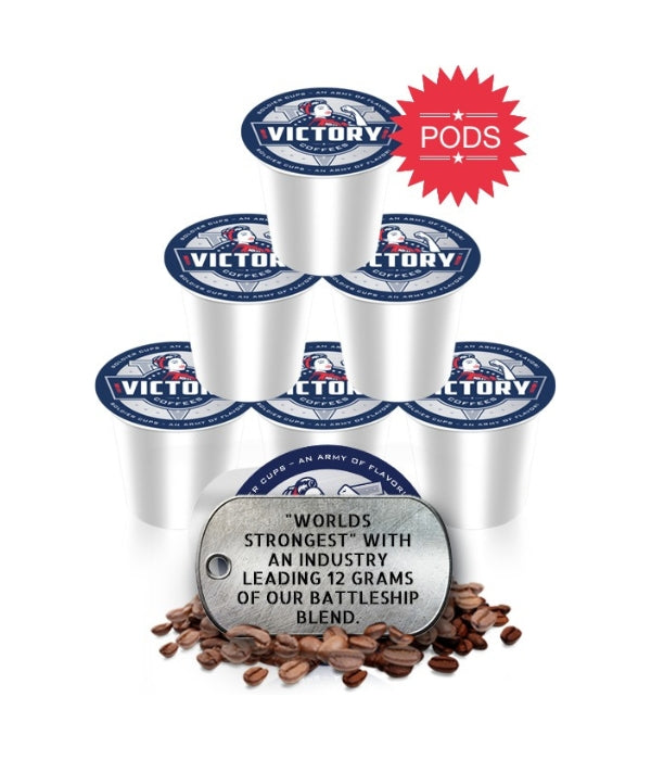 A pyramid stack of Victory Coffee's Solider KCup Pods, behind a Dog Tag sitting in coffee beans.